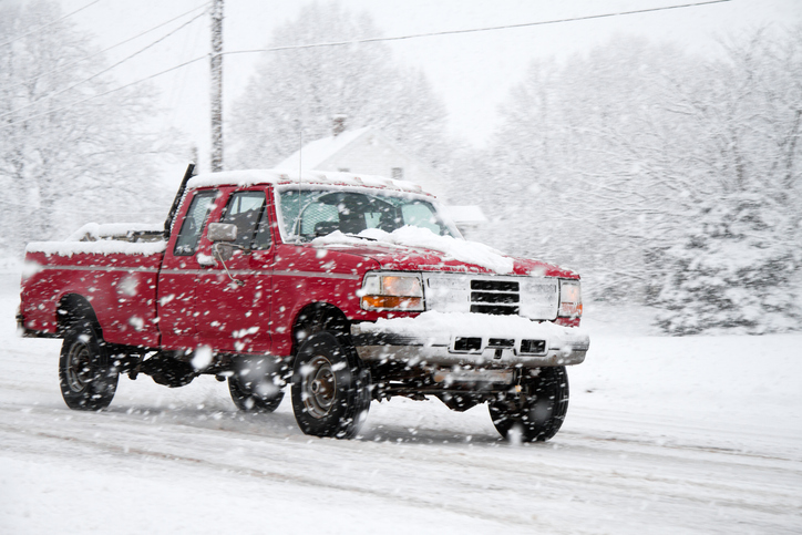Truck Driving on snowy road during storm